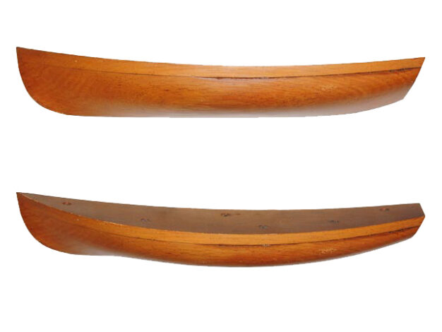 Two views of the half model for the Columbia dinghy on a white background, one showing the profile and the other slightly from above showing the shape of the sheer