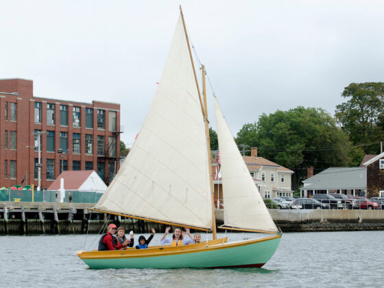 Sailing instructor Nick Nadalin (left) and Hugh Cole students Julian Munoz, Joel Ferro, Brooke Sousa, Kendra Ascoli (from left) ride aboard a 12.5 ft. wooden boat during a sailing class 2018